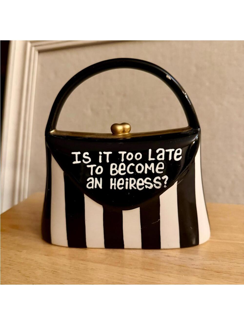 Our Name is Mud black and white ceramic handbag piggy bank.